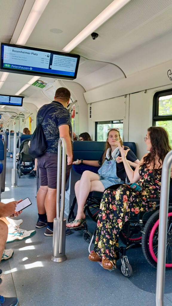 Group of three travellers on public transport in Munich