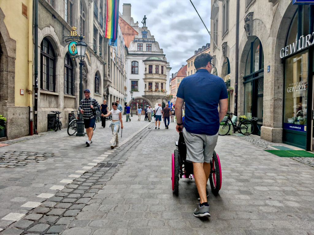 The rear of Richard as he pushes Georgina's manual wheelchair