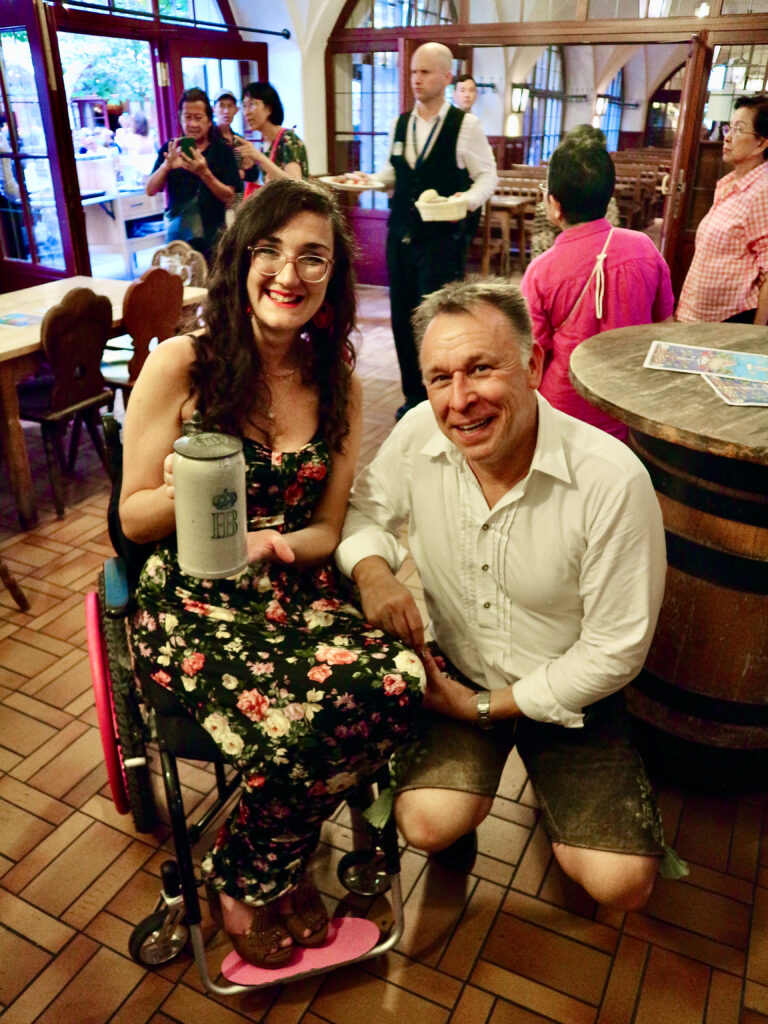 Georgina is with Tobi in traditional Bavarian dress. She holds his antique stein