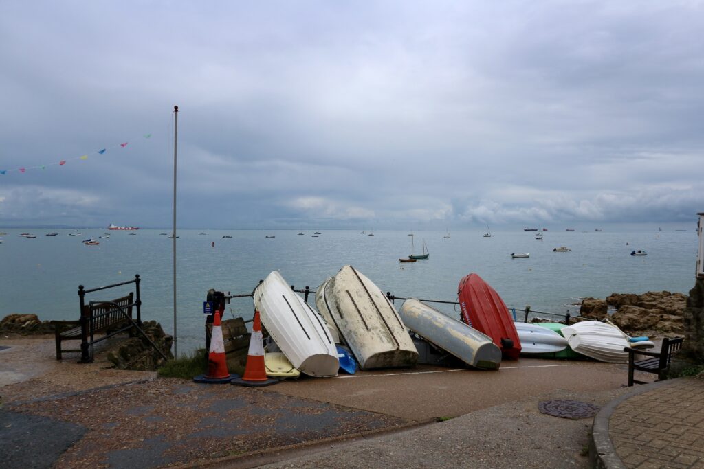 Boats propped up with coastal view behind