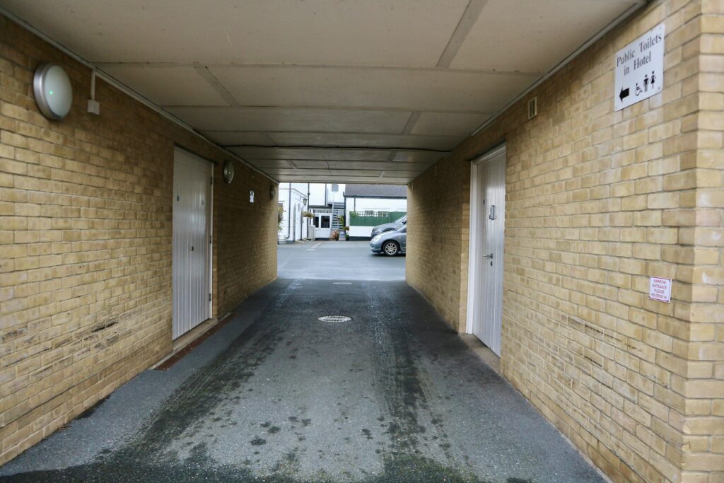 Archway into parking area at rear of the hotel to car park