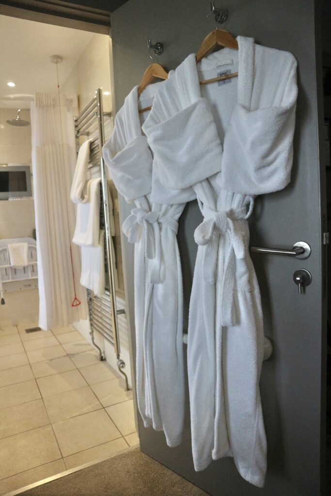 Dressing gowns on back of hotel bathroom door