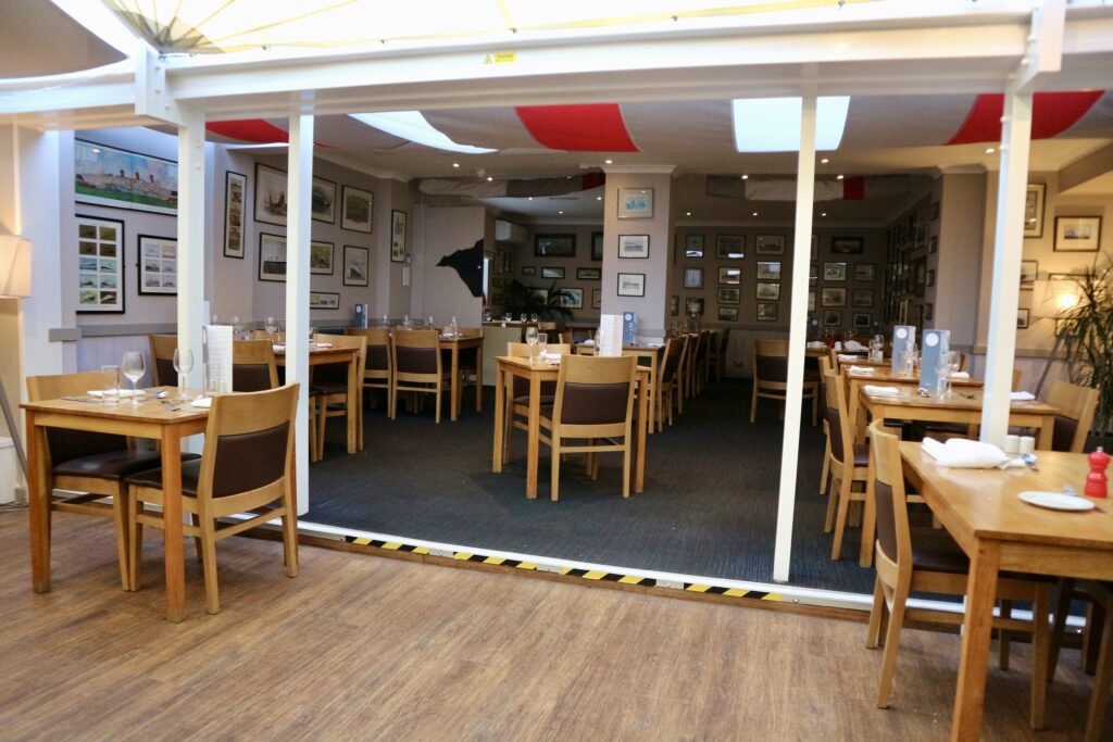 The Bistro dining area, level access wooden floor with very slight step clearly marked with yellow and black tape