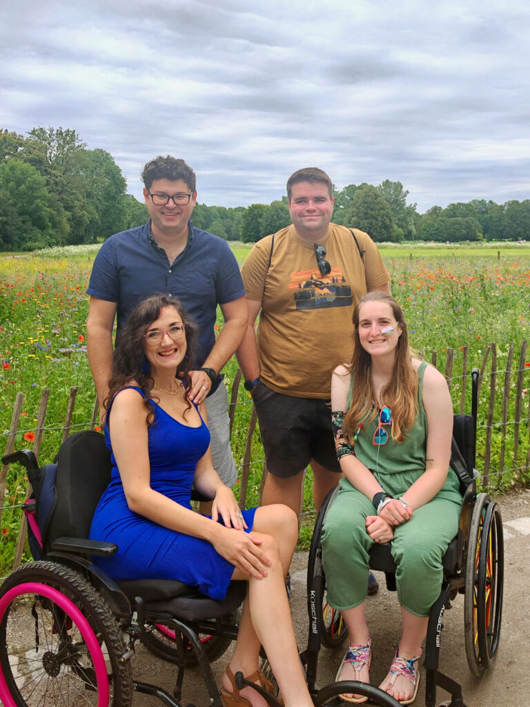 A group of four adults in Munich - Mary and Georgina use manual wheelchairs